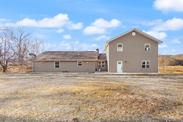 back of property featuring a patio area and a chimney