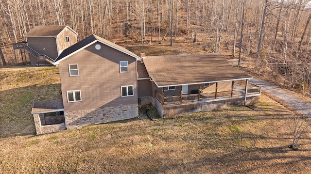 exterior space featuring a lawn and roof with shingles