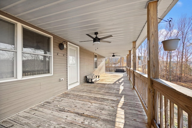 wooden terrace featuring a porch and ceiling fan