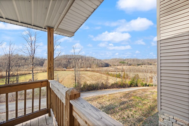 exterior space with a rural view and a wooded view