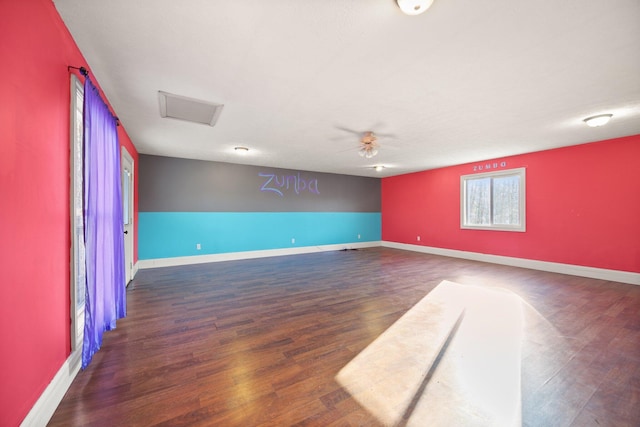 spare room featuring baseboards, a ceiling fan, and wood finished floors