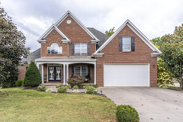 traditional home with concrete driveway, french doors, a porch, and brick siding