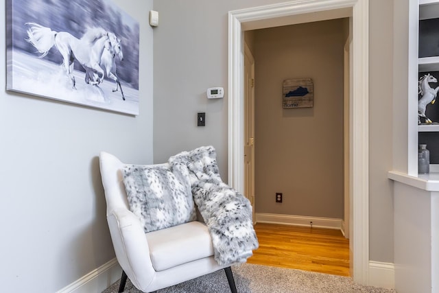 living area with wood finished floors and baseboards