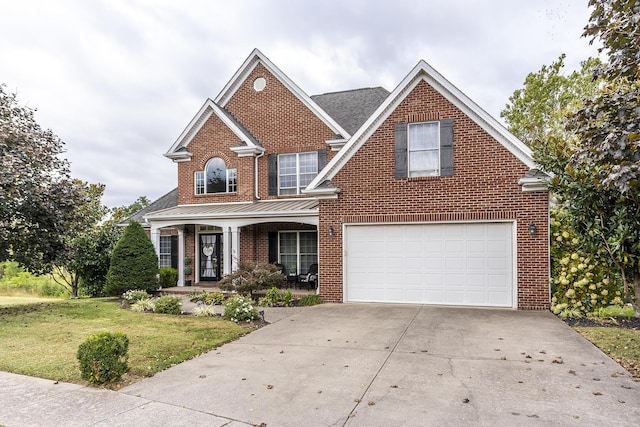 traditional-style house with brick siding, a porch, concrete driveway, a garage, and a front lawn