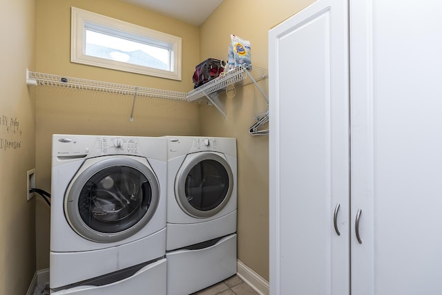 washroom featuring laundry area, washer and clothes dryer, and baseboards