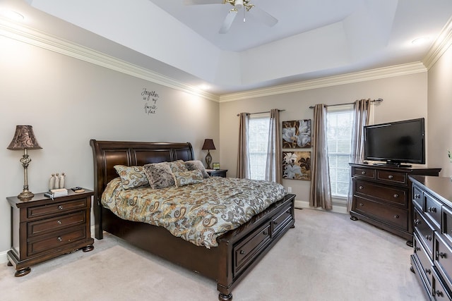 bedroom featuring a tray ceiling, light colored carpet, crown molding, and ceiling fan