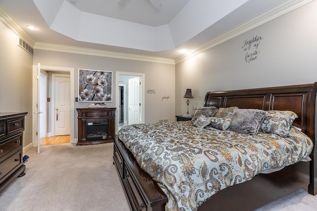 bedroom with visible vents, a raised ceiling, crown molding, and light colored carpet