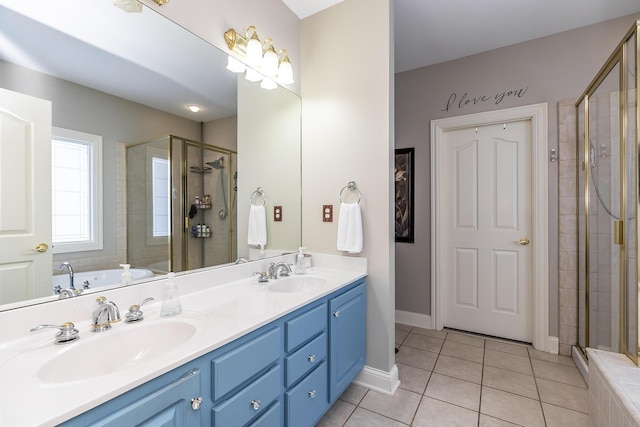 full bath with a stall shower, a sink, and tile patterned floors