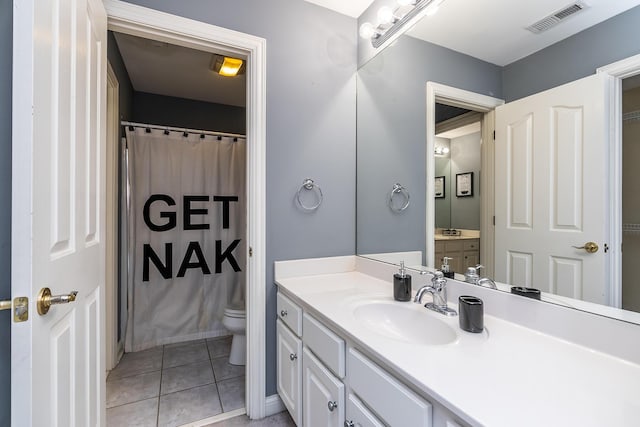 bathroom featuring toilet, a shower with shower curtain, vanity, visible vents, and tile patterned floors