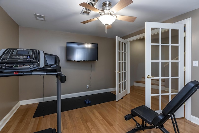 workout area with wood finished floors, a ceiling fan, visible vents, baseboards, and french doors