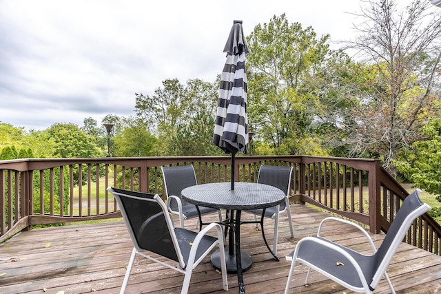 wooden terrace with outdoor dining area