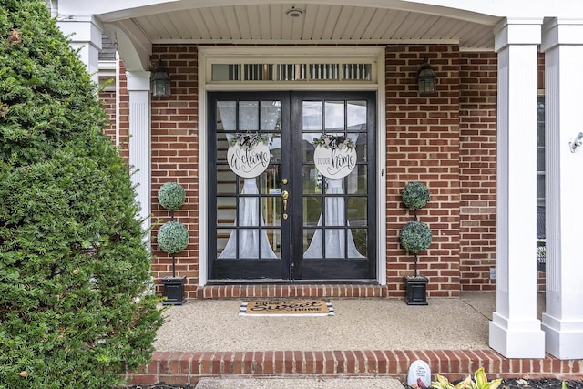 entrance to property with brick siding and french doors