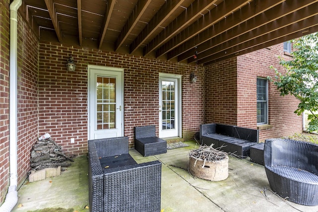 view of patio featuring an outdoor living space with a fire pit