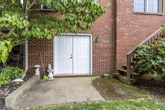 doorway to property with brick siding