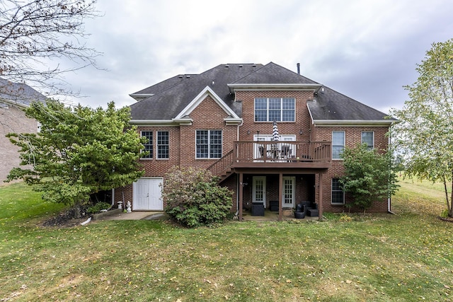 rear view of house with a lawn, a patio, stairway, a wooden deck, and brick siding