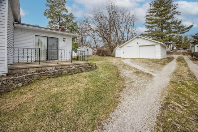 view of yard featuring a garage and an outdoor structure