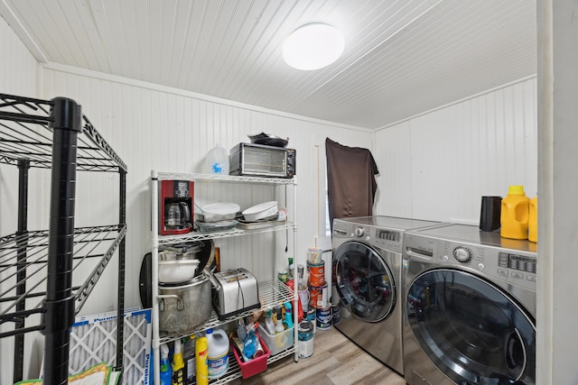 laundry room with laundry area, independent washer and dryer, and wood finished floors
