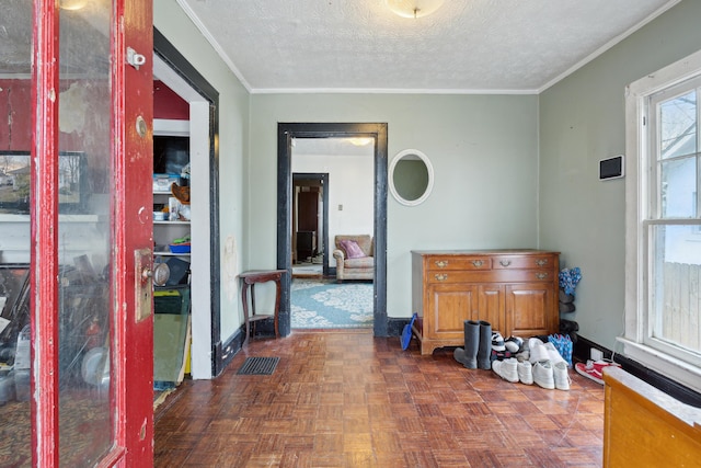 dining area featuring visible vents, crown molding, a textured ceiling, and baseboards