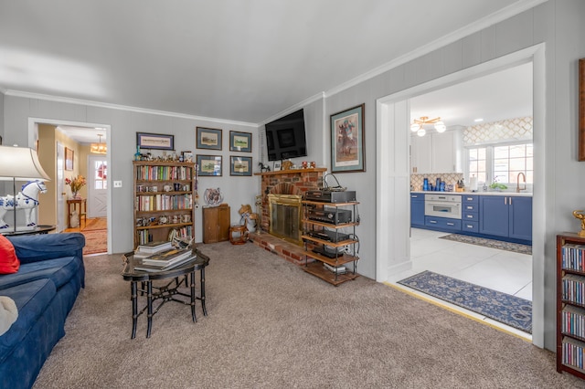 living room with a brick fireplace, ornamental molding, and light colored carpet