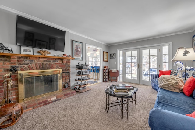 living area featuring french doors, a fireplace, carpet flooring, and crown molding