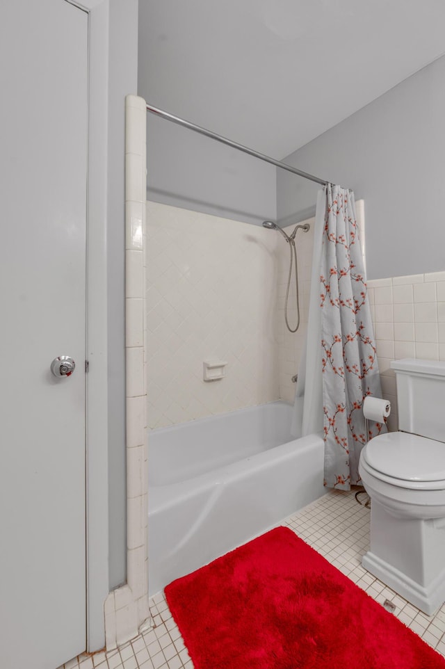 full bathroom with toilet, tile patterned flooring, tile walls, and shower / bathtub combination with curtain