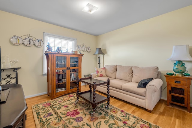 living area with light wood finished floors and baseboards