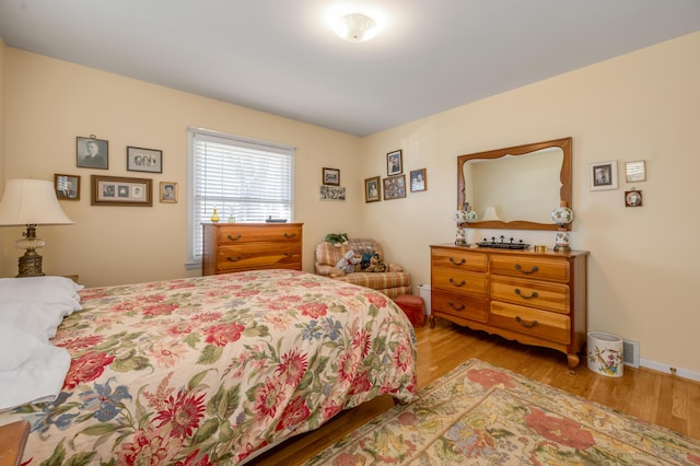 bedroom featuring wood finished floors and baseboards