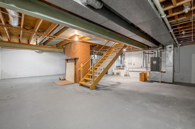 unfinished basement featuring heating unit and stairway