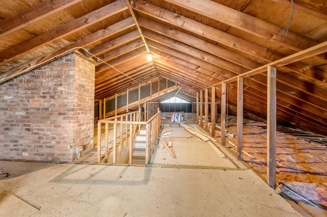 unfinished attic with an upstairs landing