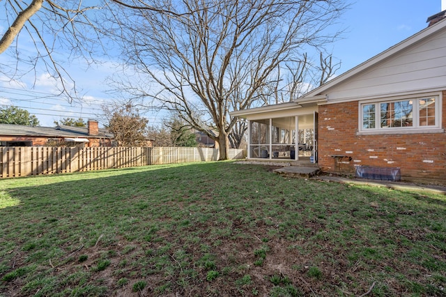 view of yard featuring fence private yard and a sunroom