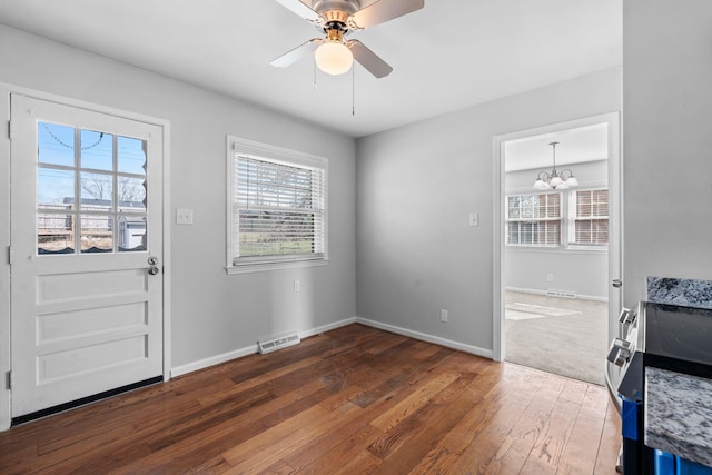 entryway with plenty of natural light, wood-type flooring, visible vents, and baseboards