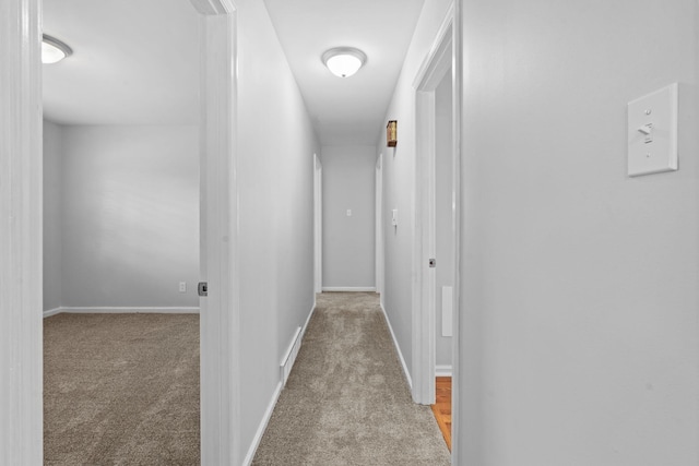 corridor with carpet floors and baseboards