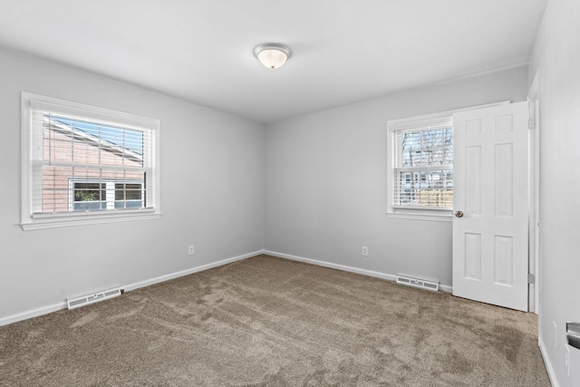 interior space featuring multiple windows, carpet flooring, and visible vents