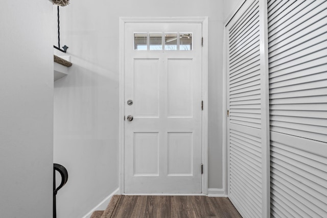 entryway featuring dark wood-style floors and baseboards