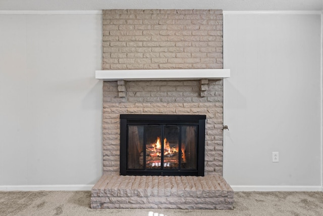 details featuring carpet floors, ornamental molding, and a fireplace