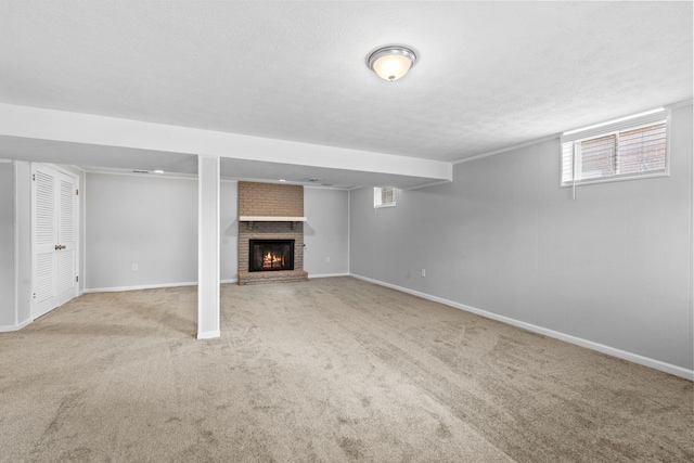 basement featuring a textured ceiling, carpet, a fireplace, and baseboards