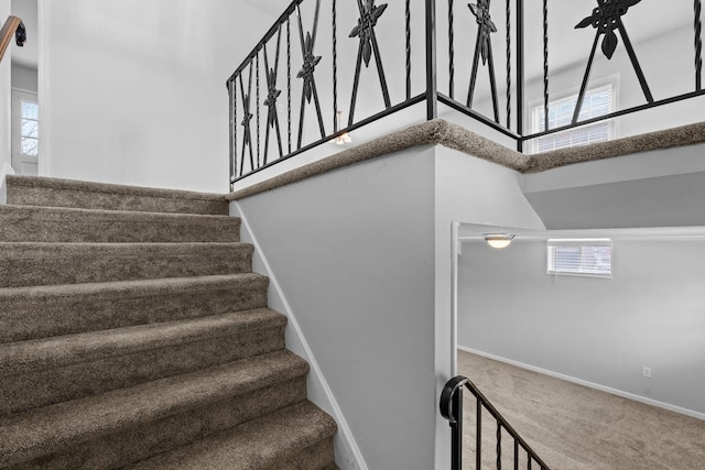 stairs with carpet floors and baseboards