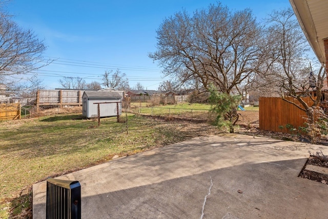 view of yard with a patio area, a storage unit, an outdoor structure, and fence private yard