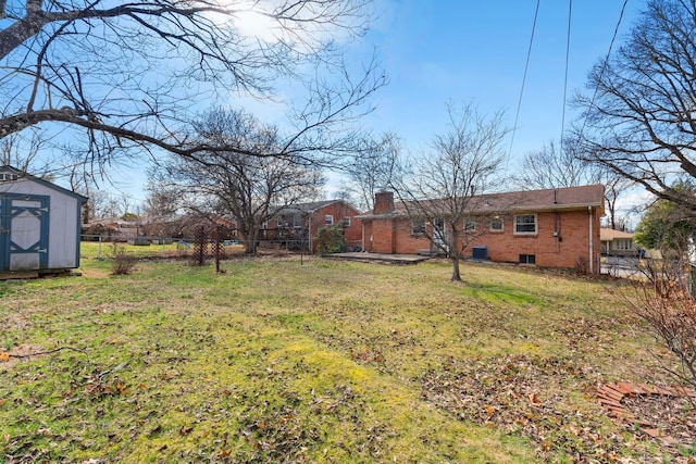 view of yard featuring an outbuilding, fence, and a storage unit