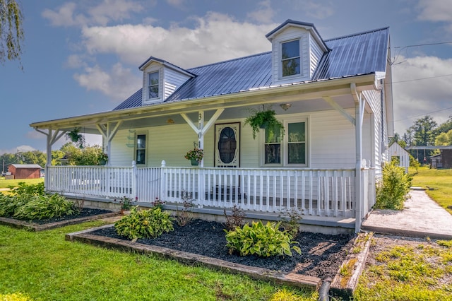 view of front facade featuring covered porch and metal roof