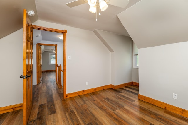 additional living space with lofted ceiling, ceiling fan, baseboards, and wood finished floors