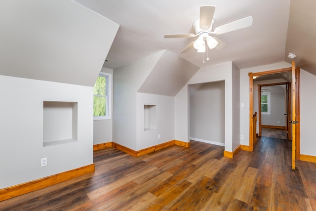 additional living space featuring vaulted ceiling, wood finished floors, a ceiling fan, and baseboards