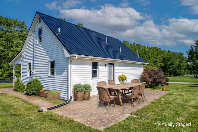 back of house with a yard, metal roof, and a patio