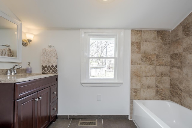 bathroom featuring tile patterned flooring, vanity, visible vents, and baseboards