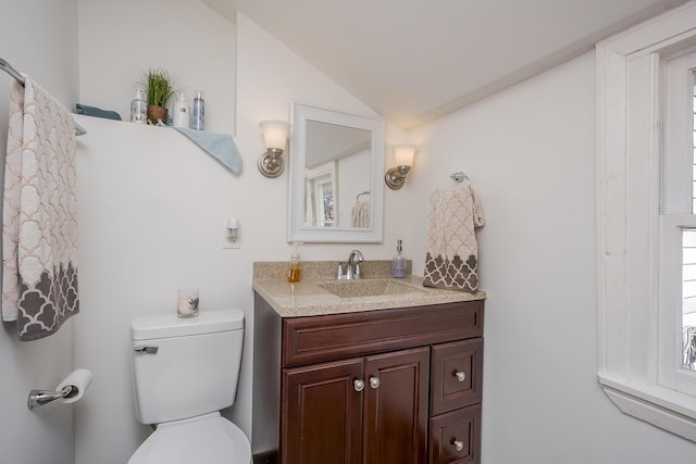 bathroom featuring vaulted ceiling, vanity, and toilet