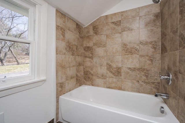 bathroom featuring lofted ceiling and shower / bath combination