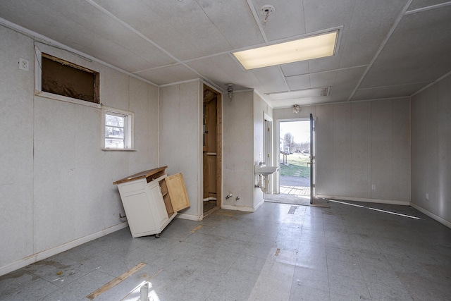 interior space featuring light floors and baseboards