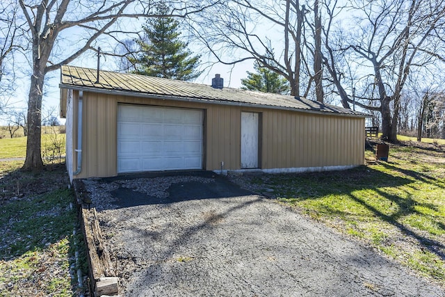 detached garage featuring aphalt driveway