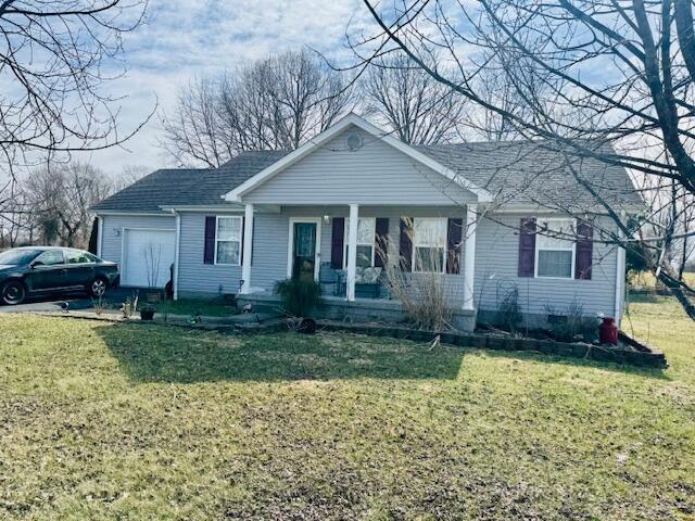 80 Rustic Haven Dr, Campbellsville, KY 42718 - view of front of house with a garage, a shingled roof, a front lawn, and a porch
