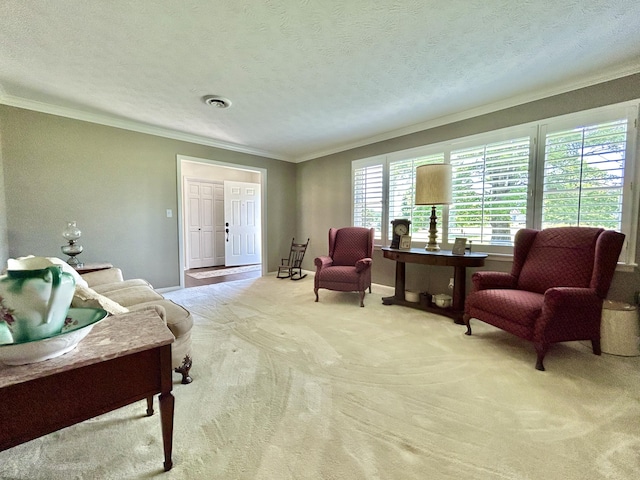 sitting room with crown molding, visible vents, carpet flooring, a textured ceiling, and baseboards